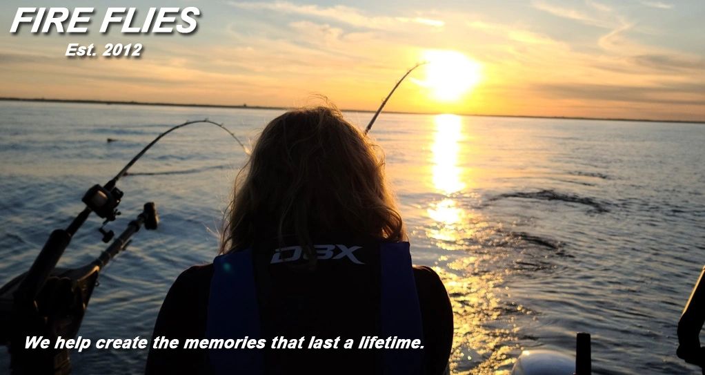 Sunset on Lake Michigan as a child reels in her fish.