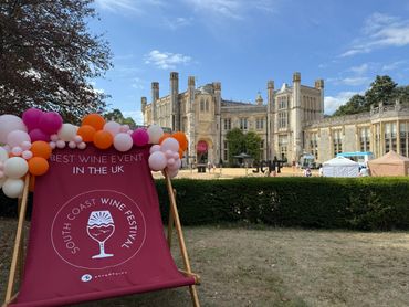 South Coast Wine Festival with balloons and a historic building.