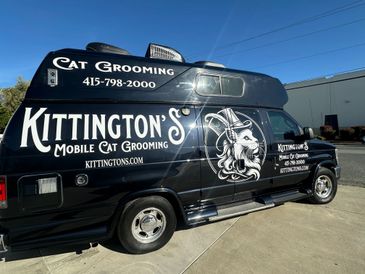 Mobile cat grooming van with detailed cat illustration and contact info.