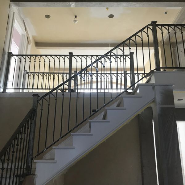 Image of a custom steel handrail up stairs in a private home.
