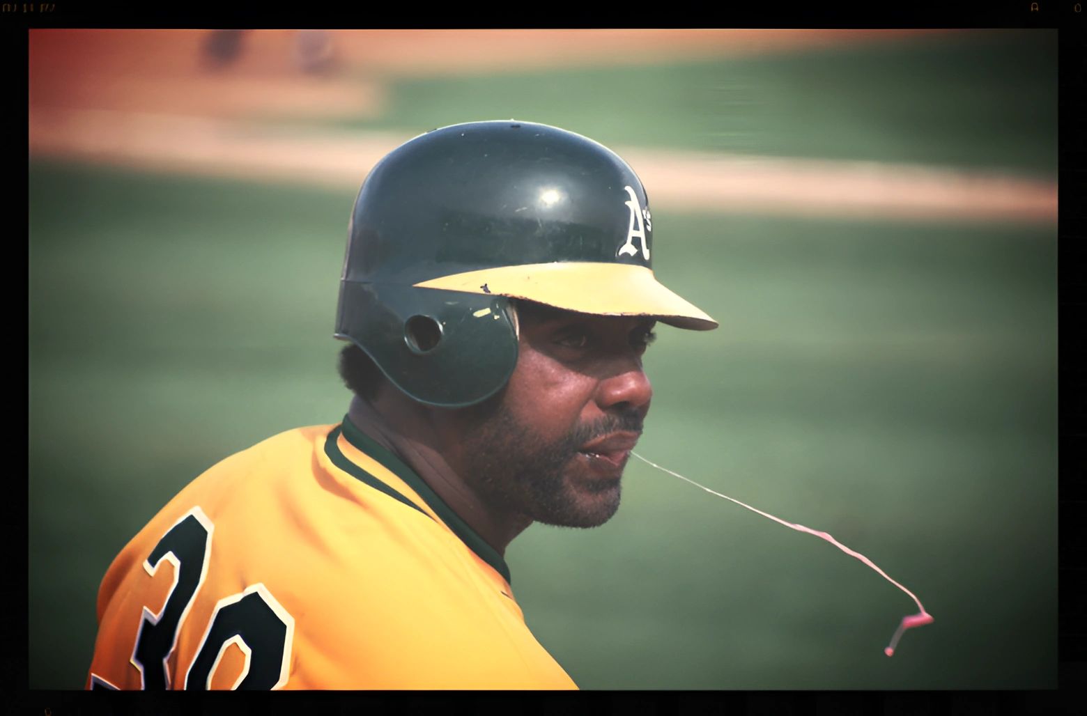Baseball player in helmet chews gum.