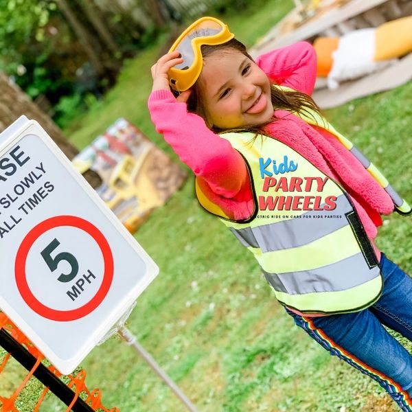 a kid dressed up and having fun at a kids party wheels construction party. 
