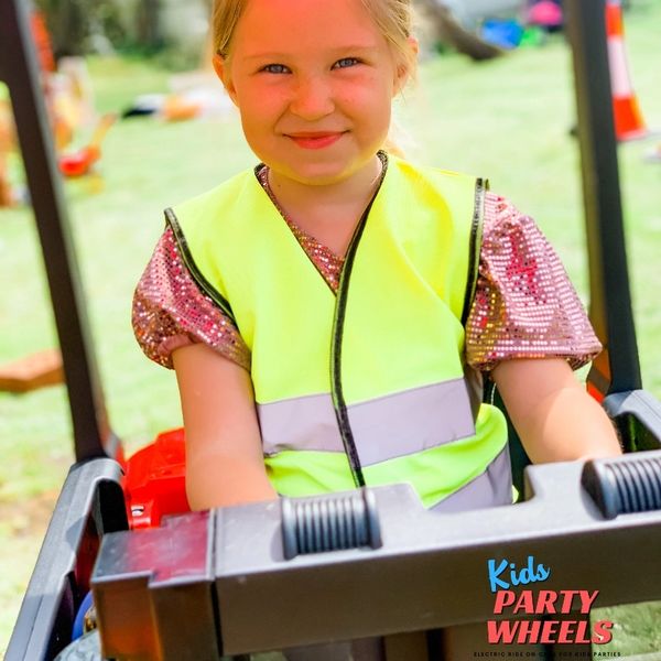 a kid driving a forklift truck at a kids party wheels party 