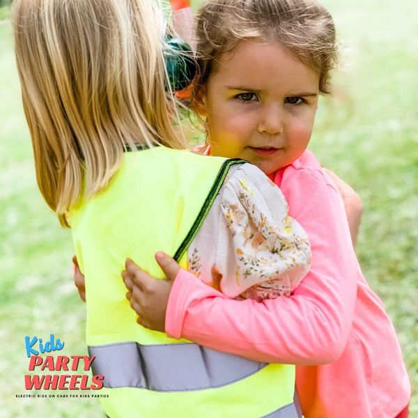 a girl giving a hug at a kids party wheels party 