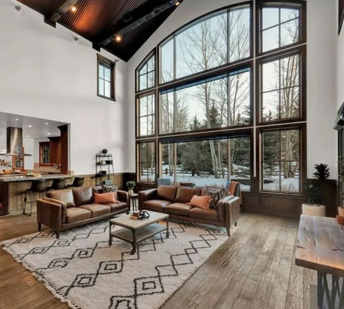 Stack of books next to pencils in a holder and a camera.