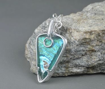 Wire-wrapped labradorite pendant with silver wire.