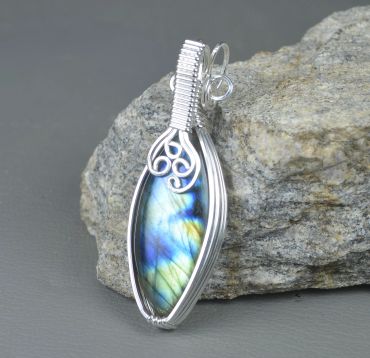 Silver wire-wrapped labradorite pendant with blue and green hues.