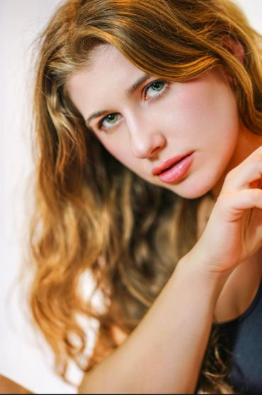 Close-up portrait of a woman with wavy hair.