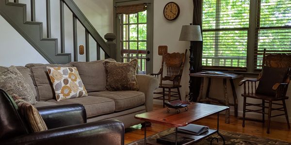 A picture of the furniture and the deer head placed on the wall 
