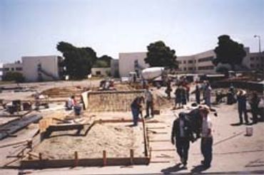 Construction site with workers preparing foundations.