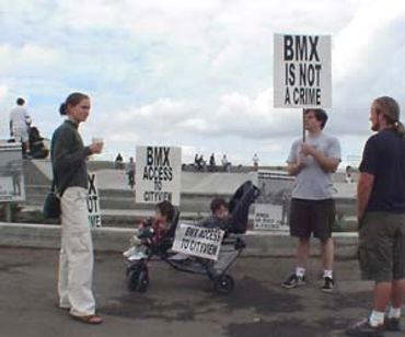 People protesting BMX access restrictions at a skatepark.
