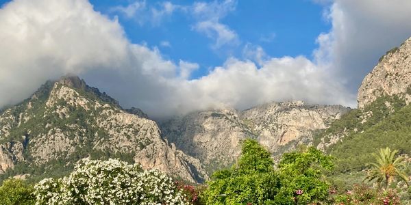 Green mountains with clouds and a blue sky