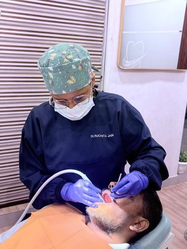 Dentist treating a male patient.