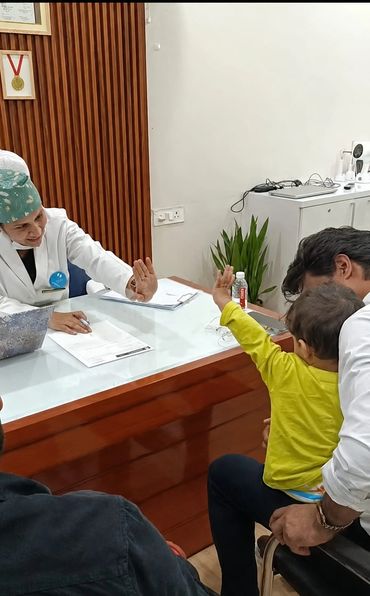 Doctor and child share a friendly hand gesture in clinic.