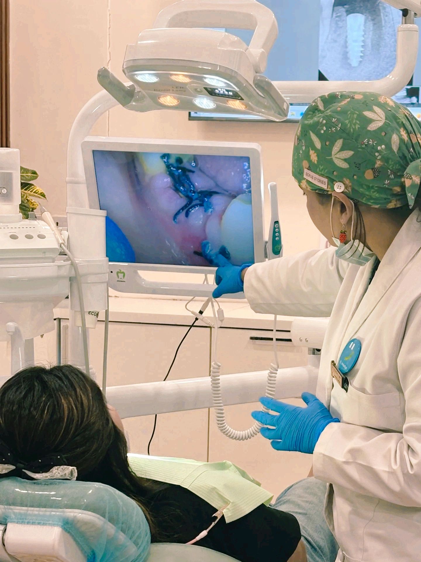 Dental care in progress with a dentist, patient, and dental monitoring equipment at Vedanta Smiles