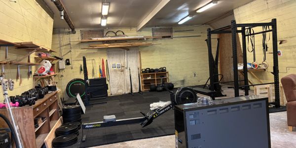 Home gym setup with various workout equipment and weights.