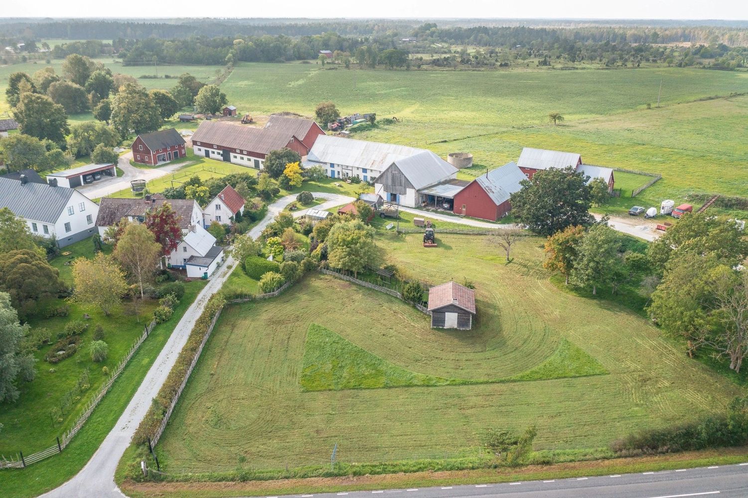 Aerial view of a large farm with multiple buildings and green fields.