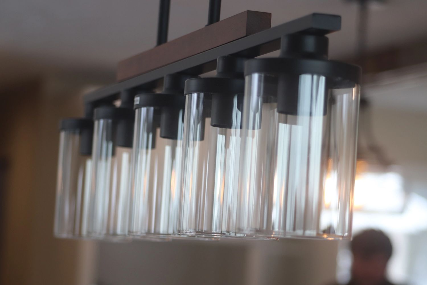 Modern industrial farmhouse light hanging over dining room table