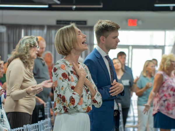 Pastor Jenny Roebert worshiping next to her son Pastor Jordan Roebert at Faith Life Naples in 2026