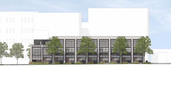 Multi-story building facade with trees in front.