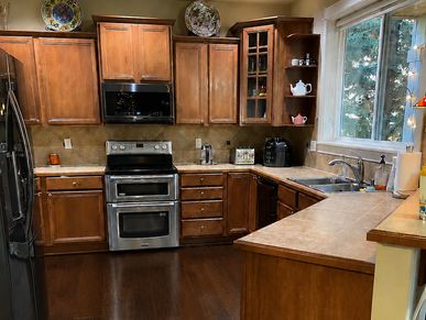 Cozy kitchen with wooden cabinets and stainless appliances.