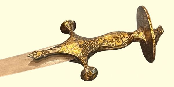 Ornate golden-hilted sword with intricate floral designs on the grip and pommel.