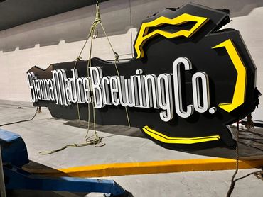 Large Sierra Madre Brewing Co. sign being installed or removed.