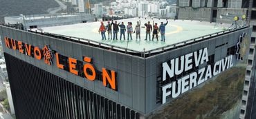 People stand on a helipad atop a skyscraper in Nuevo León.