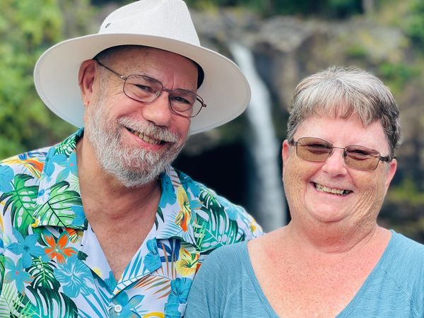 Don and Vickie Tolin with waterfall in the background.