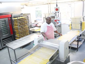 Jamaican patty pastry being rolled