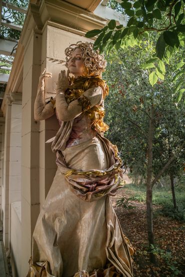 Ornate statue wrapped in garland
