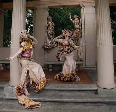 Statues posed near classic columns
