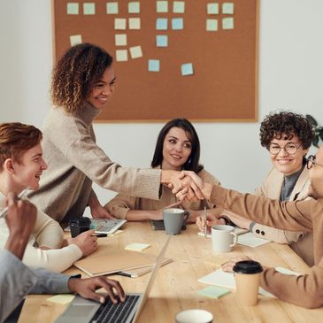 Colleagues shaking hands during a productive meeting in a cozy office setting.