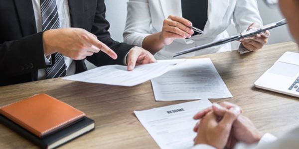 Review committee discussing resume application © Ngampol Thongsai | Dreamstime.com ID 168643489