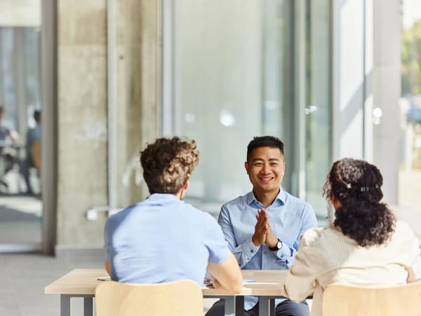 Insurance agents meeting with couple.
