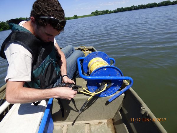 Lake Sampling - intern getting equipment ready to take a water sample.
