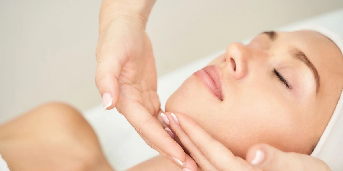 Woman receiving a facial massage.