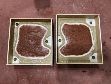 Clay sculpts that are walled up and ready to be molded so they can be made into prosthetics