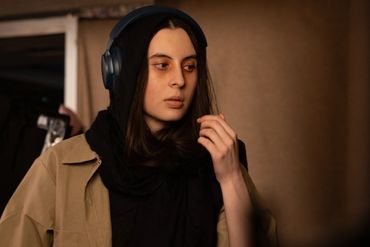 A candid photo of a woman waring headphones 