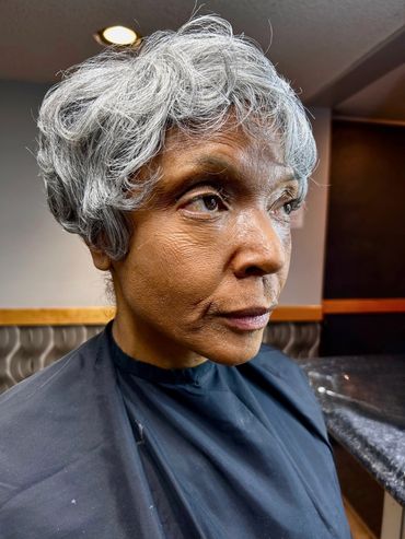 Photo of what appears to be an older woman. It's actually the same actress with old age makeup.