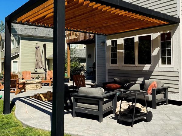 Modern backyard patio with pergola and comfortable seating.