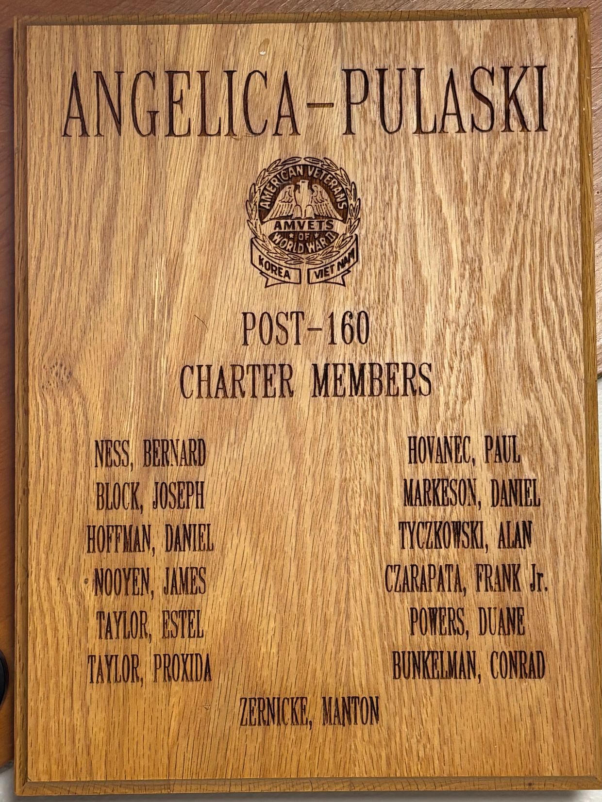 A scenic landscape featuring a sunset over mountains, reflecting colors on a calm lake.