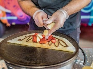 French sweet crepe with fresh sliced banana, strawberries & Nutella.