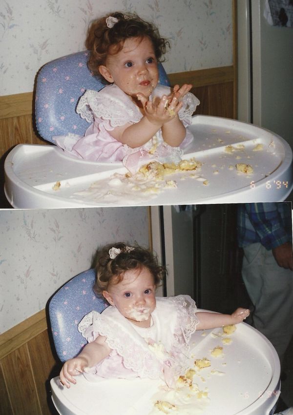 Baby enjoying messy cake in a high chair.
