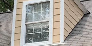 A dormer window on a house roof.