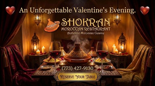 Interior of restaurant with a table with Tagine dishes of food and wine