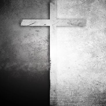 A cross casting a shadow on a textured black and white background.
