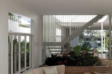 Modern living room with a glass staircase and indoor plants.