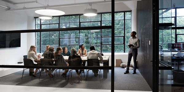 A team meeting with a presenter in a modern office space.
