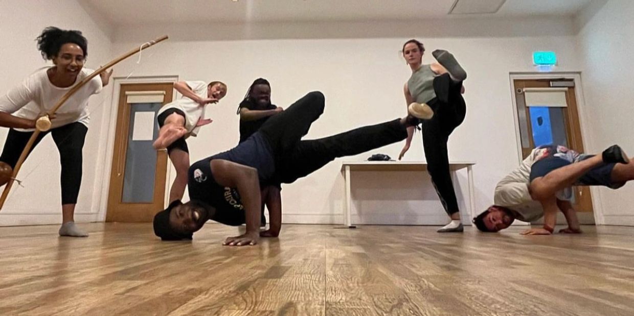 A group of people posing with acrobatic moves